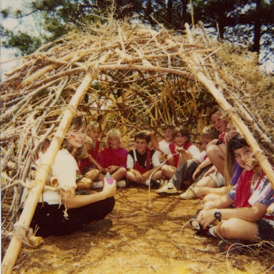 students in hand-built hut